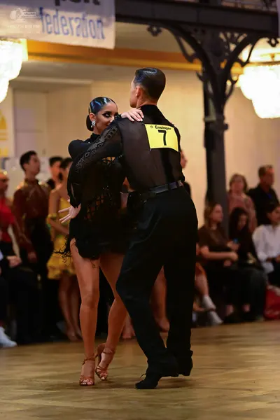 Dancesport competitor: Male dancer: black long-sleeved shirt and black trousers