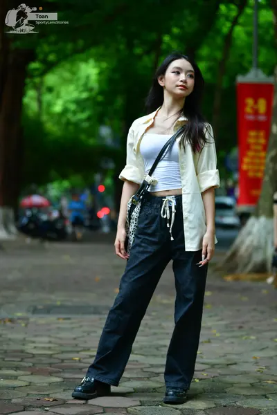 Dancesport competitor: Female dancer: white cropped top, cream-colored unbuttoned long-sleeve shirt, bl