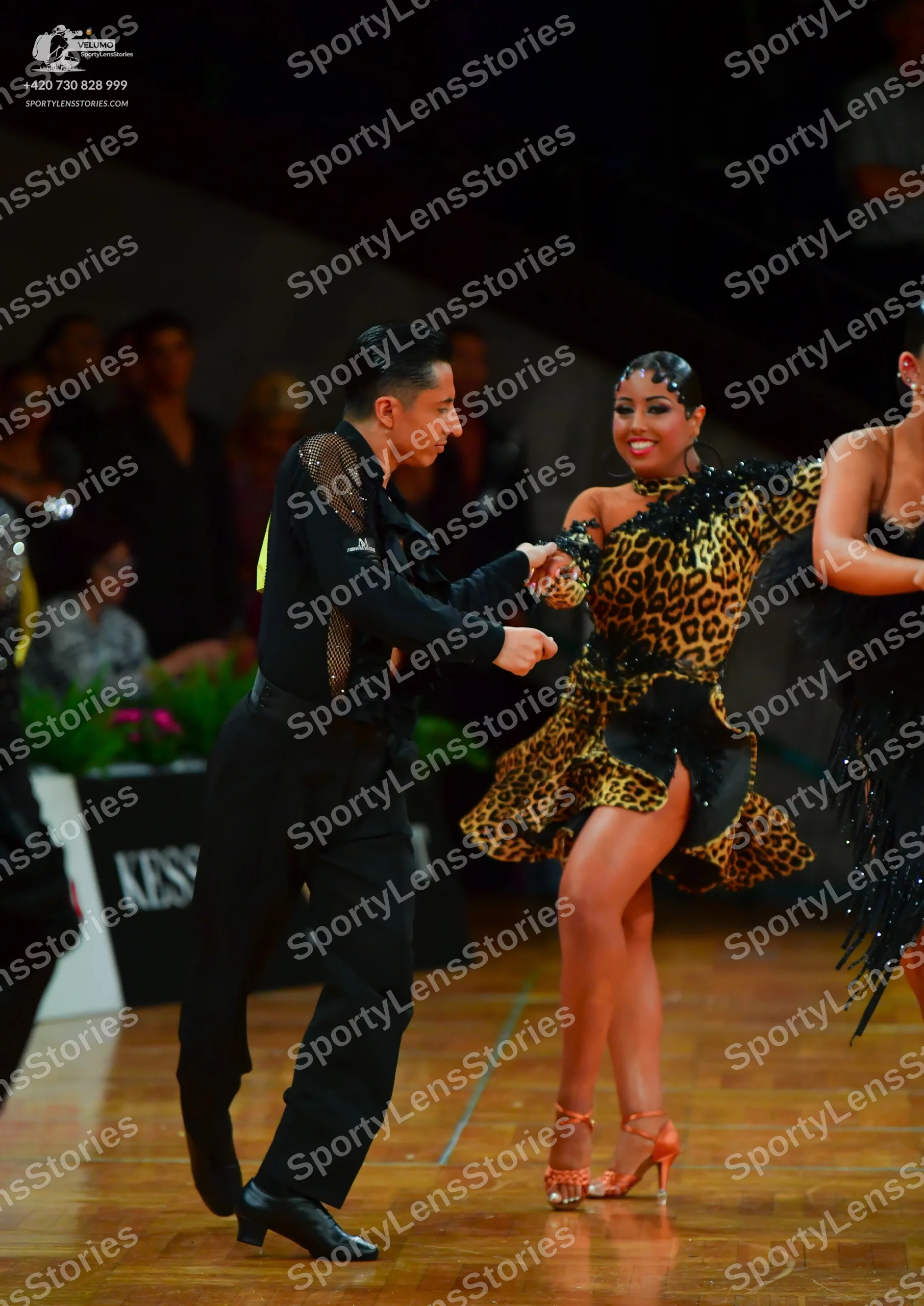 Dancesport competitor: Male dancer: black long-sleeved shirt with silver sequin embellishments on the s