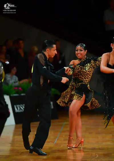 Dancesport competitor: Male dancer: black long-sleeved shirt with silver sequin embellishments on the s