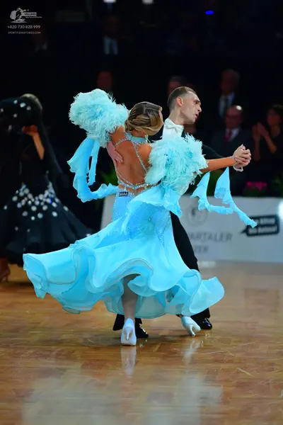 Dancesport competitor: Male dancer: black ballroom suit with a white shirt and white bow tie