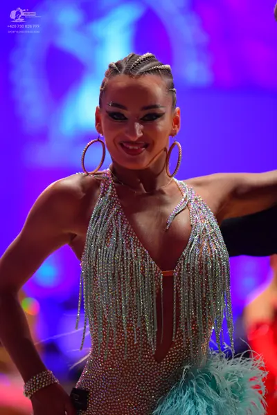 Dancesport competitor: Female dancer: light blue/silver sequined Latin dress with long beaded fringe, l