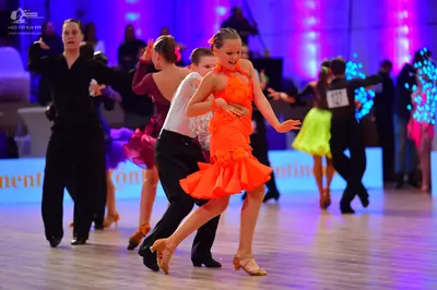 Dancesport competitor: Male dancer (left): black long-sleeved shirt and black trousers