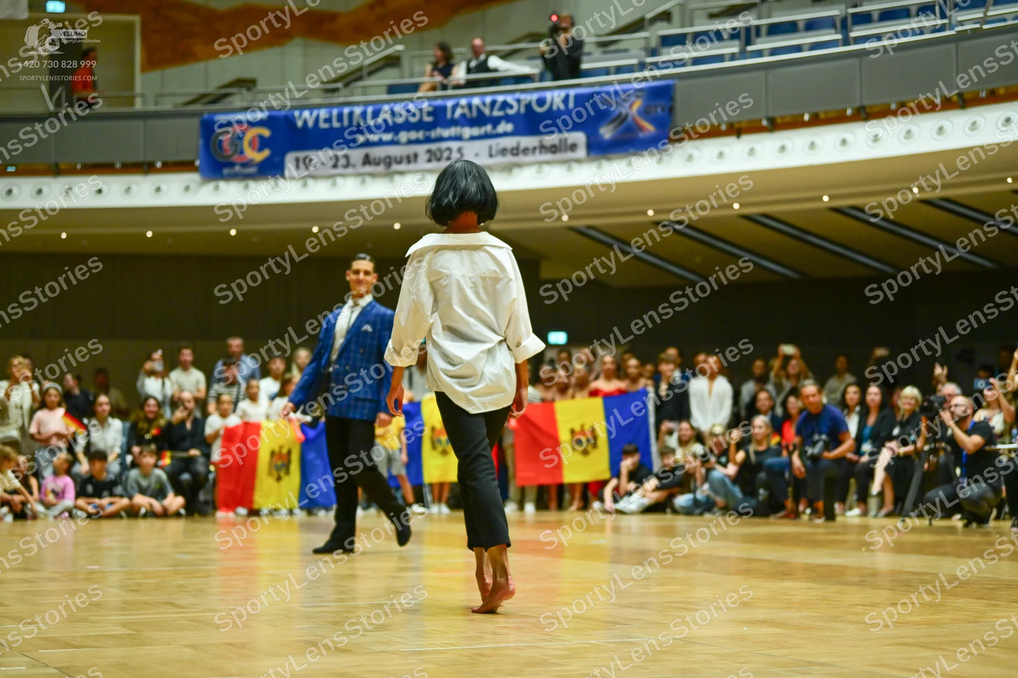 Dancesport competitor: Male dancer: bright blue blazer, white shirt, and black trousers