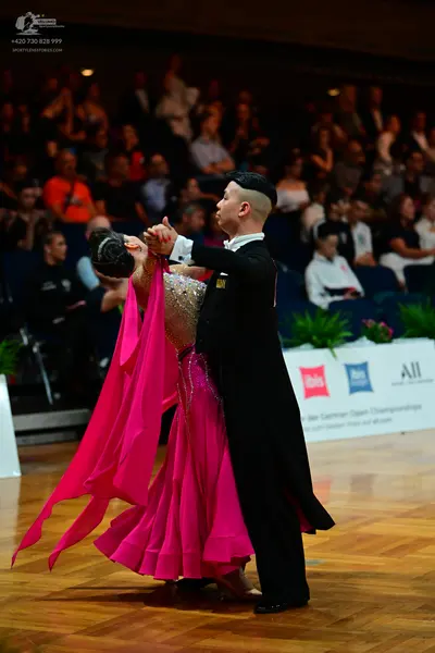 Dancesport competitor: Male dancer: black formal suit with a white shirt