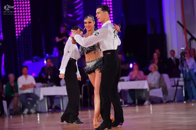 Dancesport competitor: Male dancer: white long-sleeved shirt and black trousers