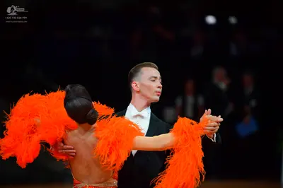 Dancesport competitor: Male dancer: black suit with a white shirt and white bowtie