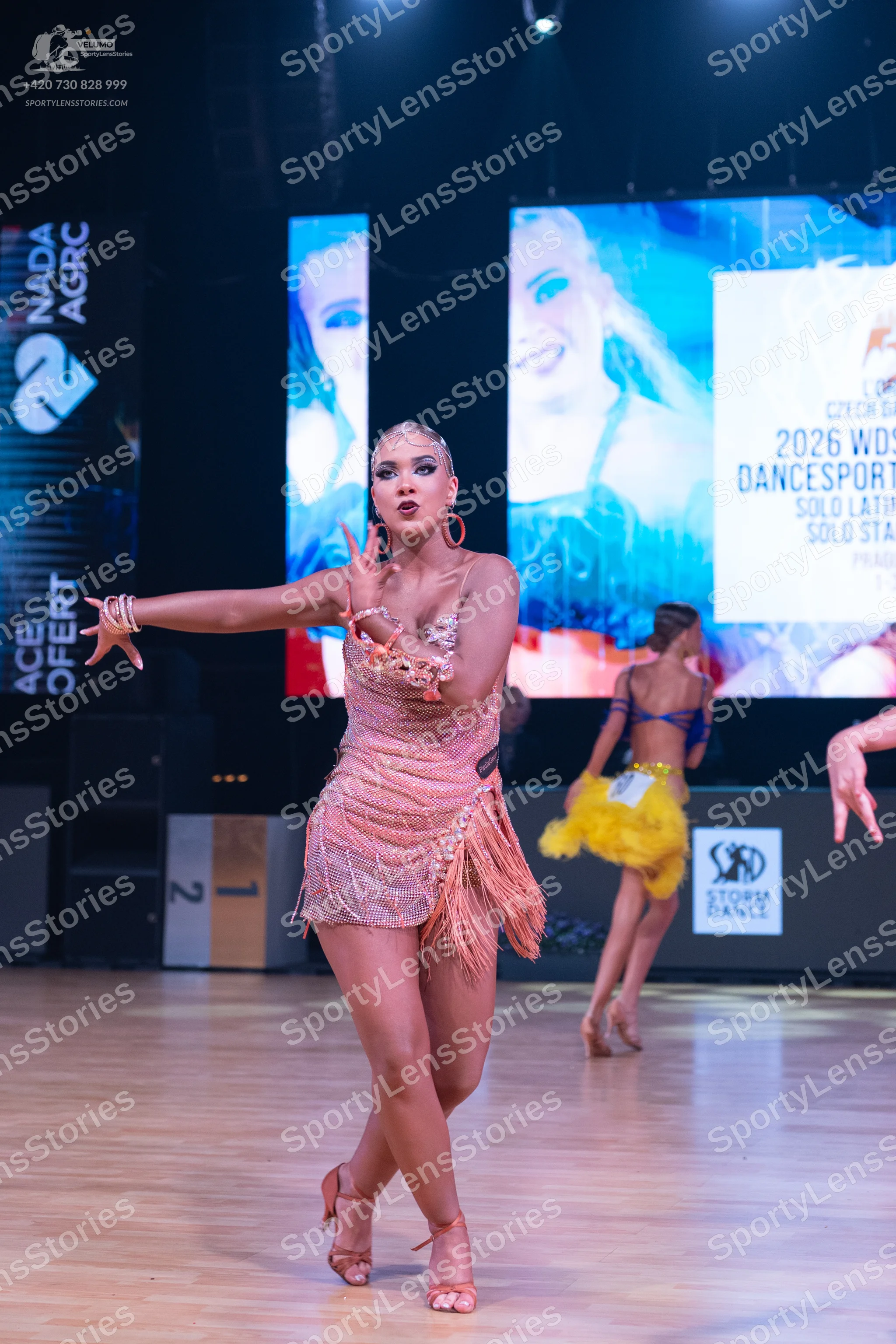 Dancesport competitor: Female dancer: nude-colored Latin dress with sequins and fringe