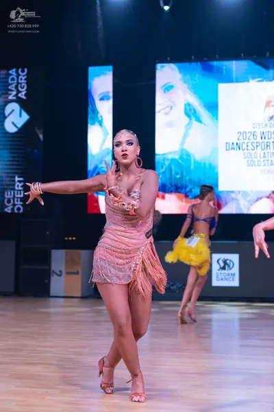 Dancesport competitor: Female dancer: nude-colored Latin dress with sequins and fringe