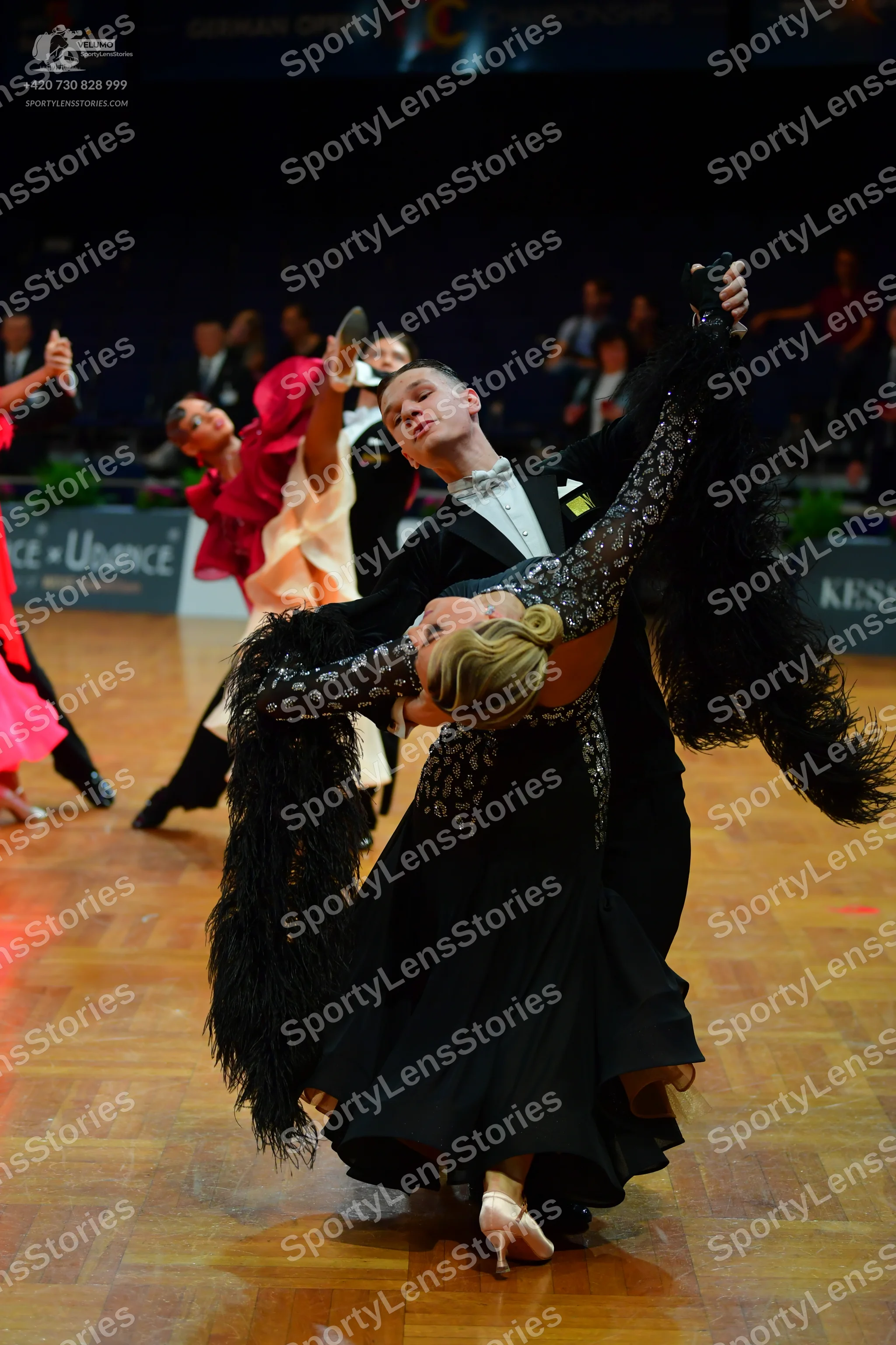 Dancesport competitor: Male dancer: black suit with a white shirt and white bowtie