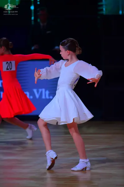 Dancesport competitor: Female dancer: red latin dress with long sleeves