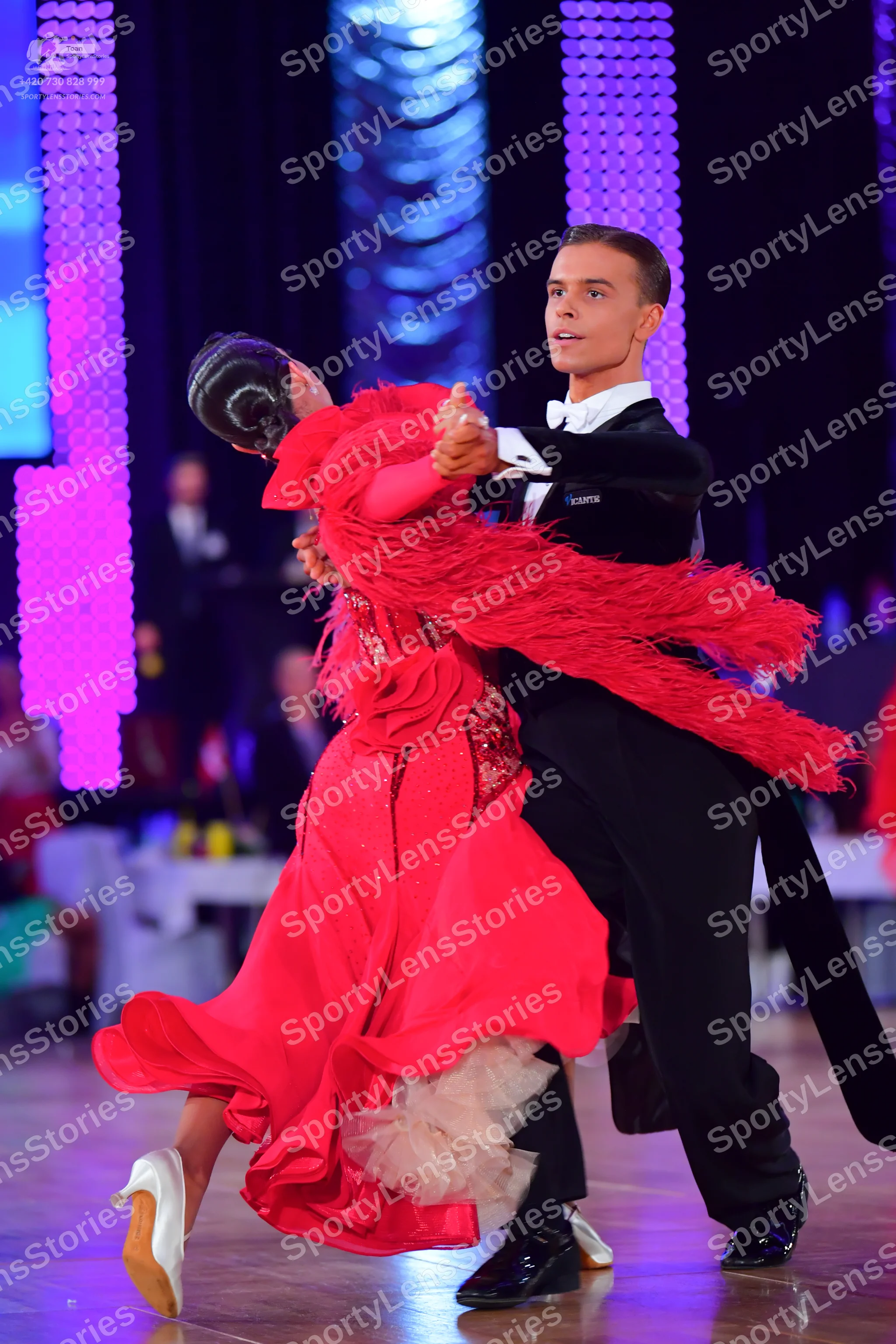 Dancesport competitor: Male dancer: black suit with a white shirt and black bowtie