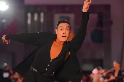Dancesport competitor: Male dancer: black long-sleeved top, unbuttoned at the chest, with black trouser