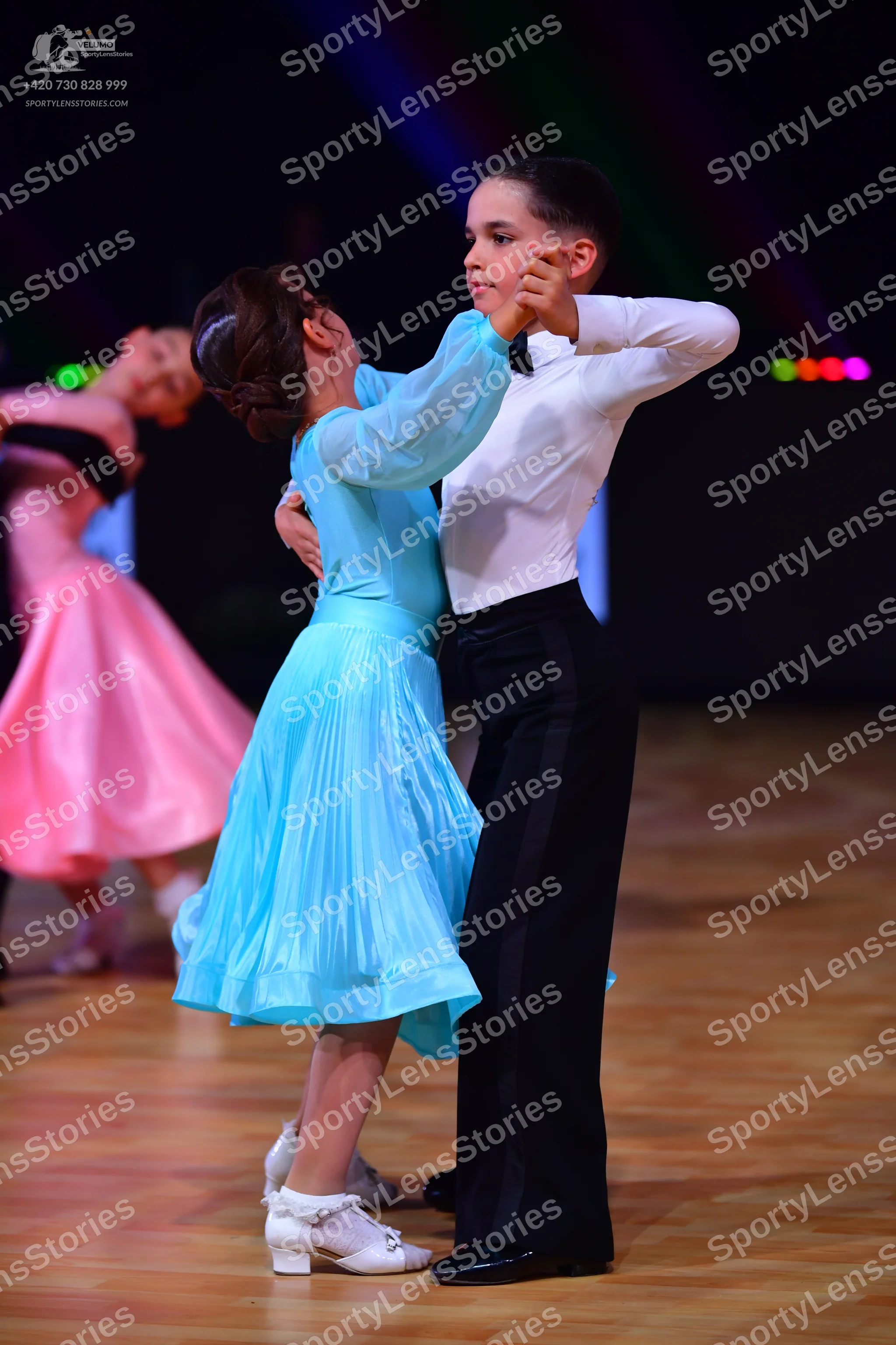 Dancesport competitor: Male dancer: white long-sleeved shirt and black trousers