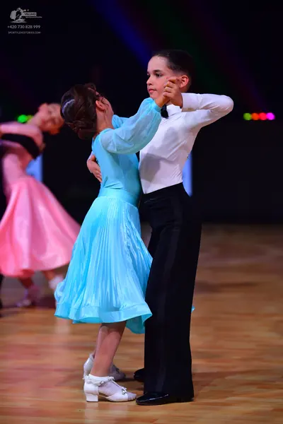 Dancesport competitor: Male dancer: white long-sleeved shirt and black trousers