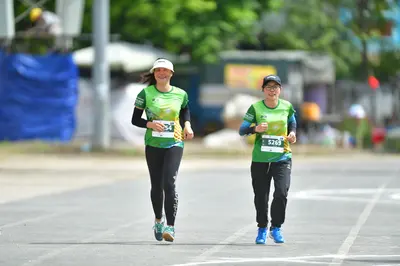 Marathon runner #5251, #5269: Runner 1: green and yellow jersey, black long-sleeve undershirt, black leggings,