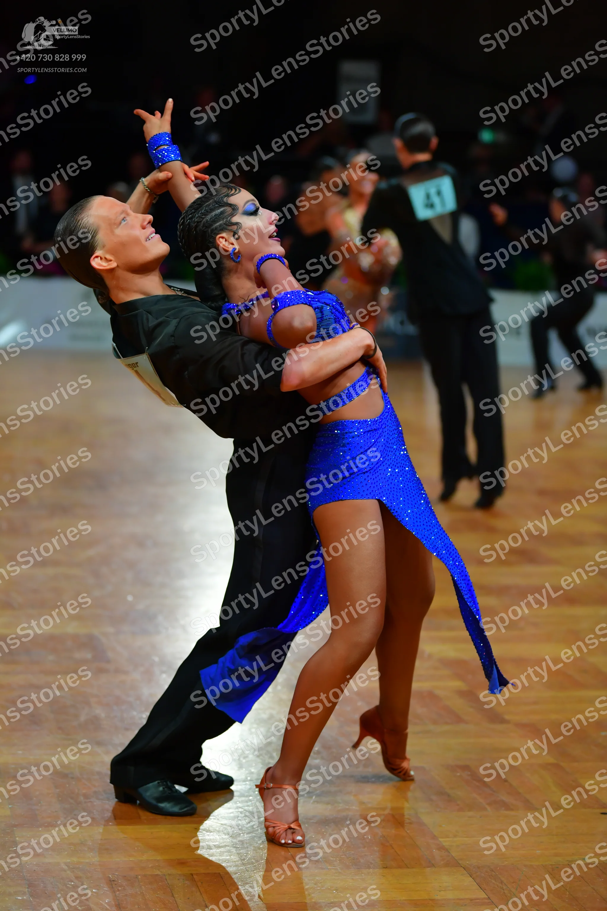 Dancesport competitor #41: Male dancer in foreground: black short-sleeved shirt and black trousers