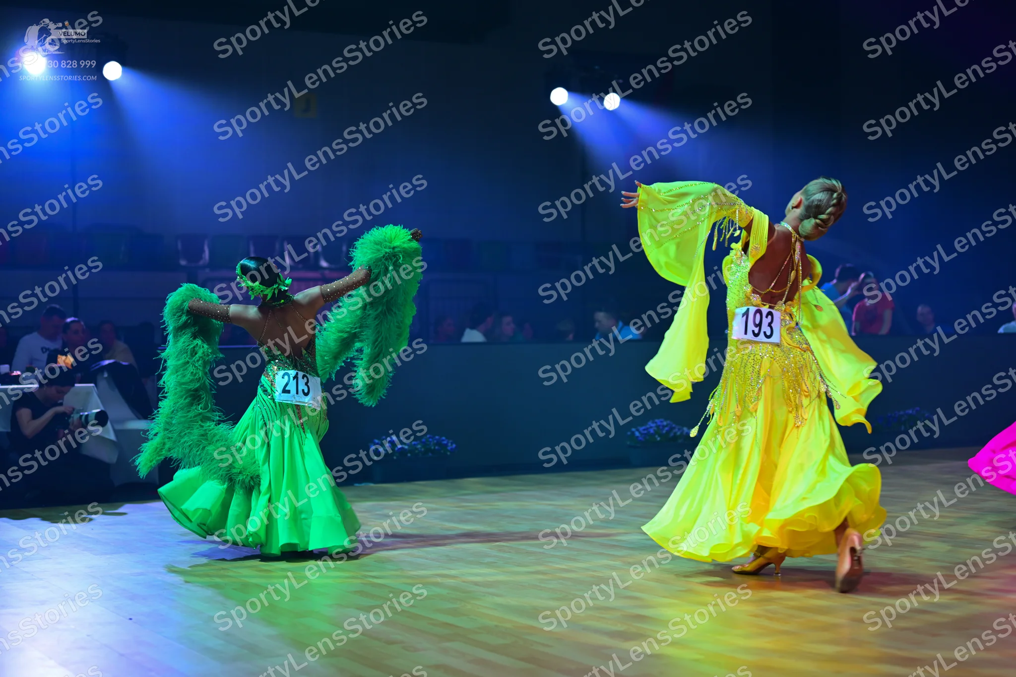 Dancesport competitor: Dancer 1: bright green ballgown with large, fluffy green feather-like accents on