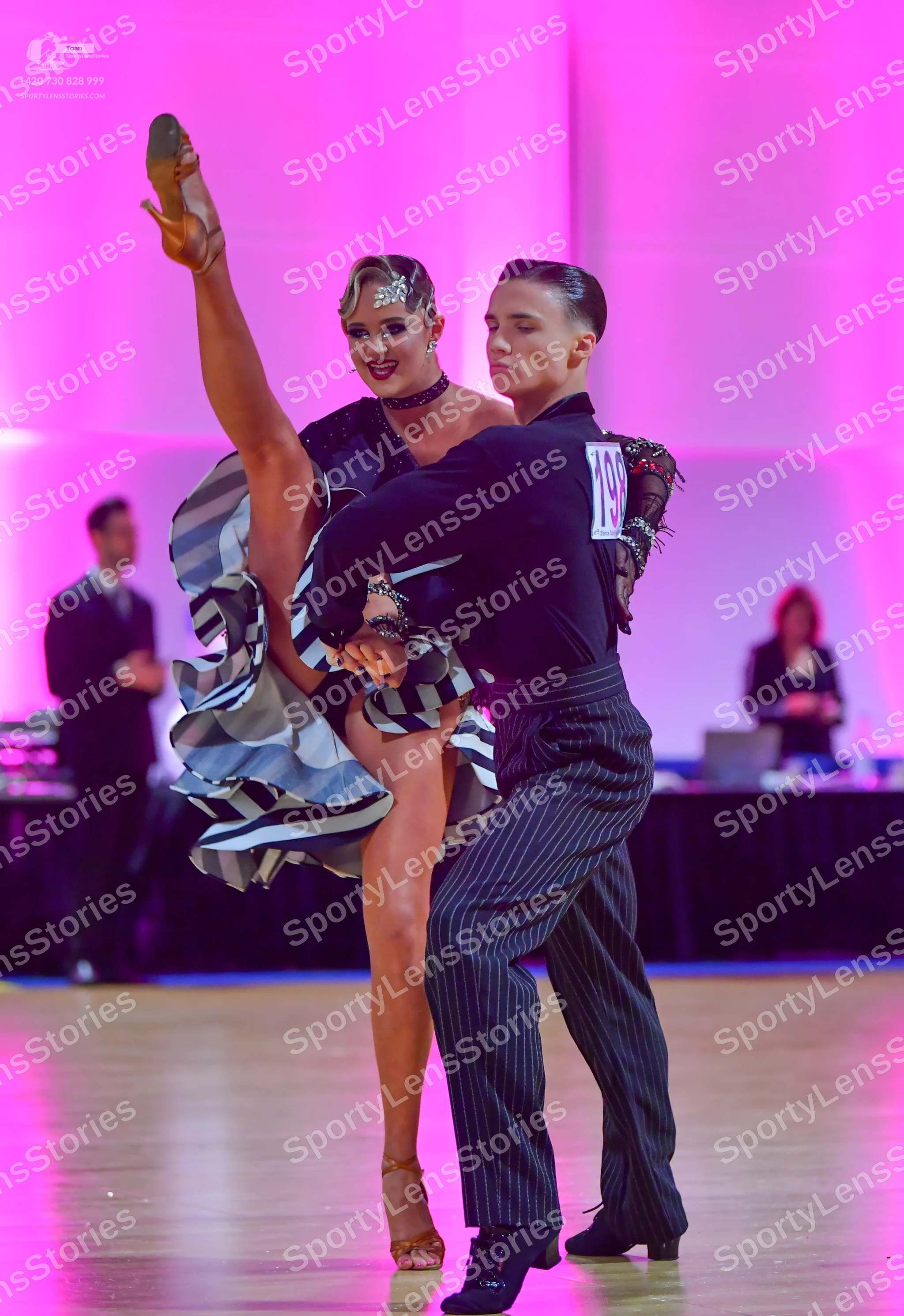 Dancesport competitor #196: Male dancer: black long-sleeved shirt with dark red patterned lace on the should