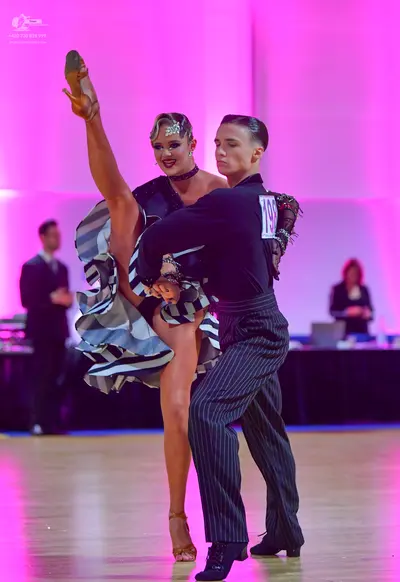 Dancesport competitor #196: Male dancer: black long-sleeved shirt with dark red patterned lace on the should