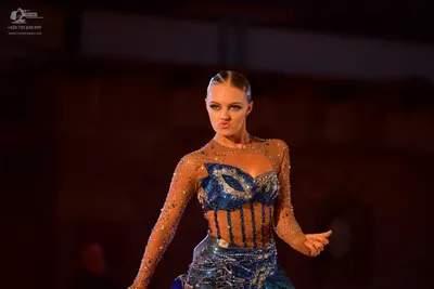 Dancesport competitor: Female dancer: blue and nude-colored Latin dance dress, heavily embellished with