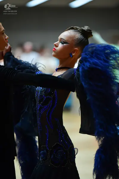 Dancesport competitor: Male dancer: black long-sleeved top