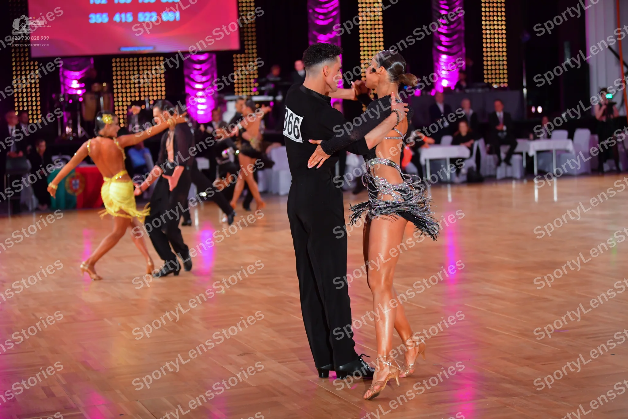 Dancesport competitor #66: Male dancer in foreground: black long-sleeved top and black trousers