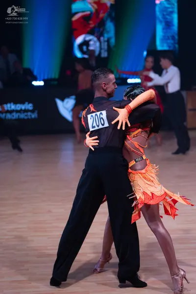 Dancesport competitor: Male dancer: black long-sleeved shirt and black trousers