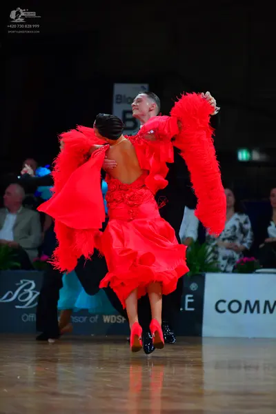 Dancesport competitor: Female dancer: red latin dress with voluminous feathery/ruffled texture