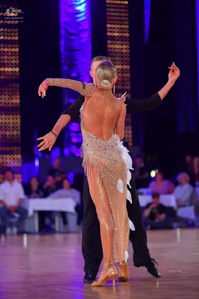 Dancesport competitor: Female dancer: champagne-colored, backless, sequined Latin dress with a high sli
