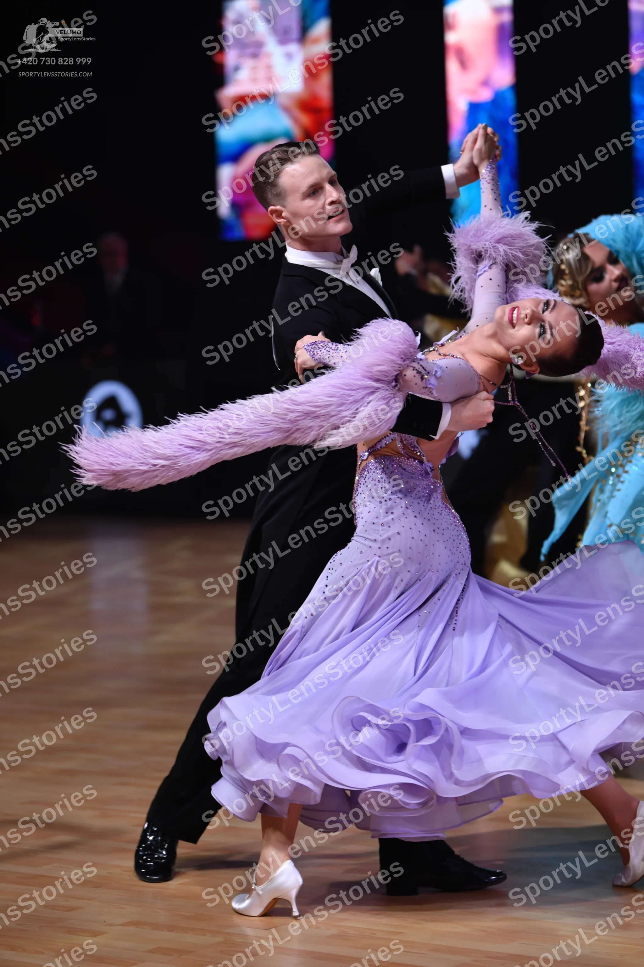 Dancesport competitor: Male dancer: black ballroom suit with a white shirt and white bow tie
