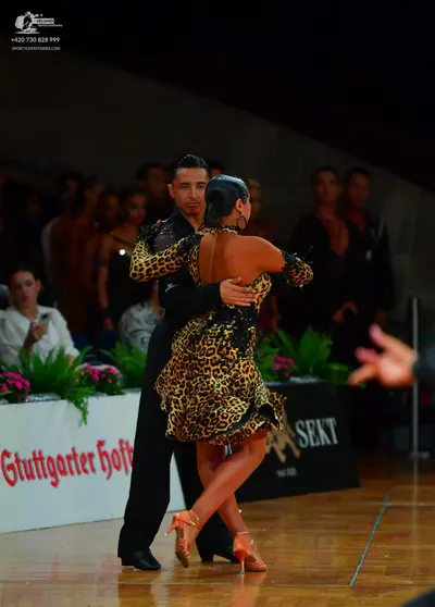 Dancesport competitor: Male dancer: black long-sleeved shirt with subtle shimmer or sequins on the slee