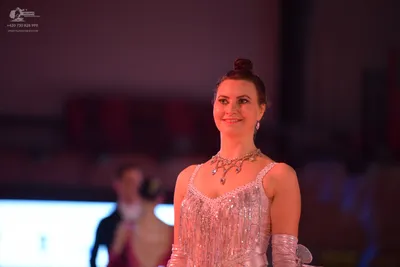 Dancesport competitor: Female dancer in foreground: sparkly pale pink/champagne Latin dress covered in 