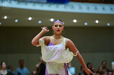 Dancesport competitor: Female dancer: white and lavender latin dance dress with sequin details, featuri