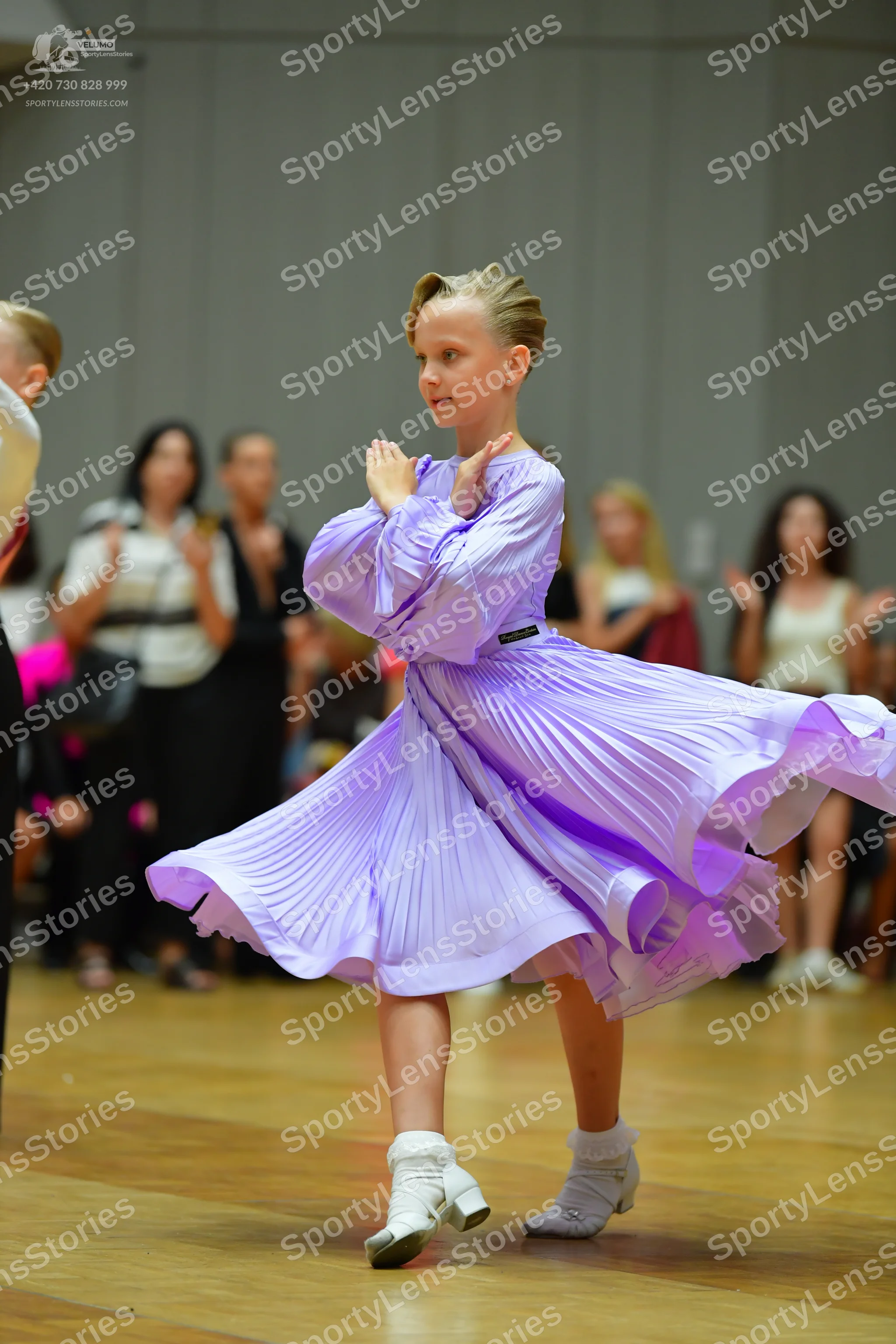Dancesport competitor: Main female dancer: light purple/lavender long-sleeved dress with a pleated, fla
