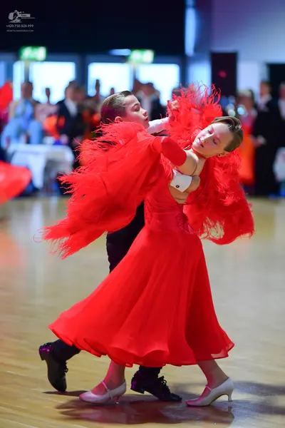 Dancesport competitor: Male dancer: white long-sleeved shirt and black trousers