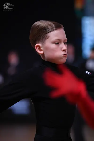 Dancesport competitor: Male dancer: black long-sleeved dance top with a high neck and a wide black wais