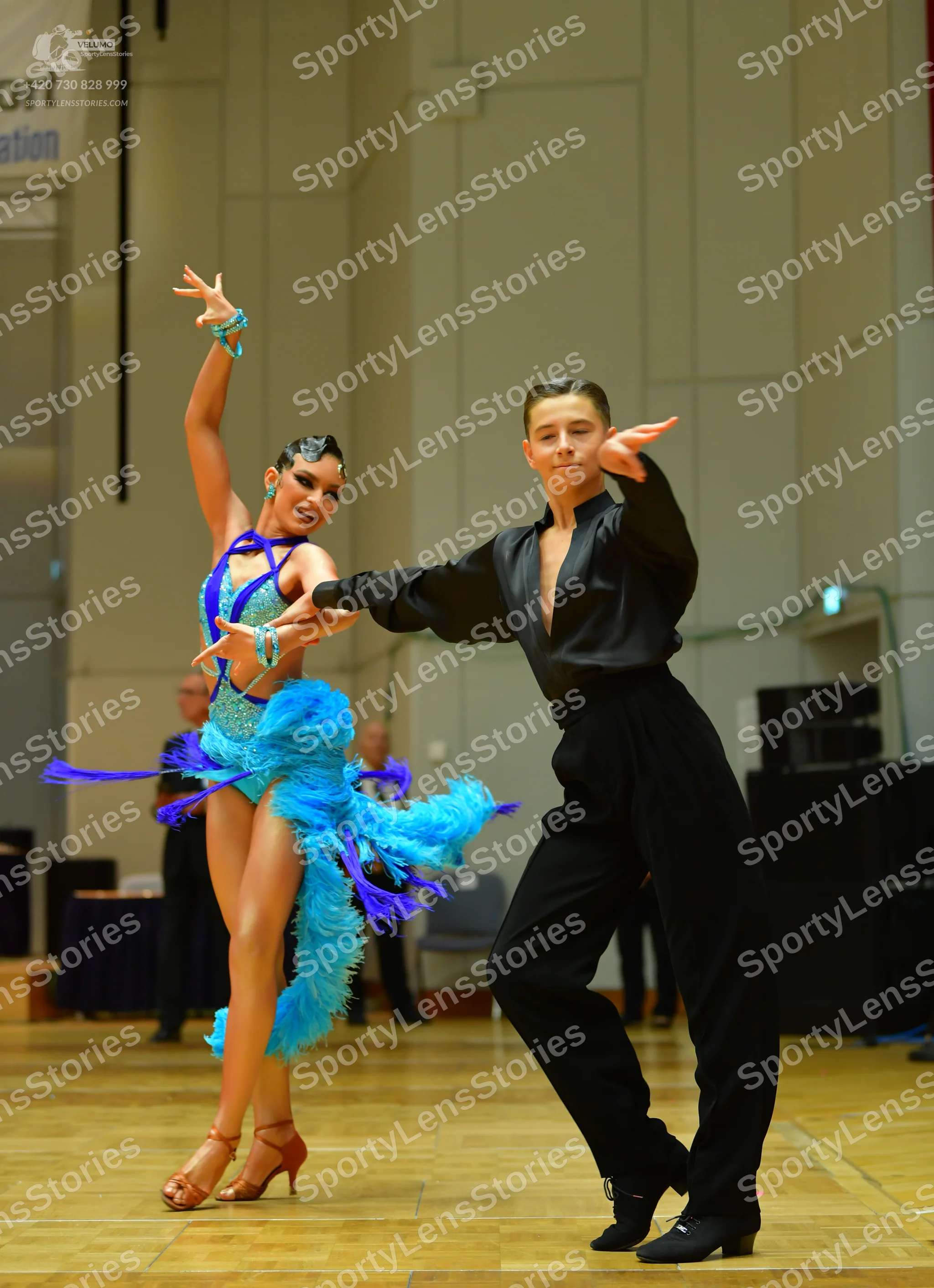 Dancesport competitor: Male dancer: black long-sleeved shirt with a deep neckline and black trousers