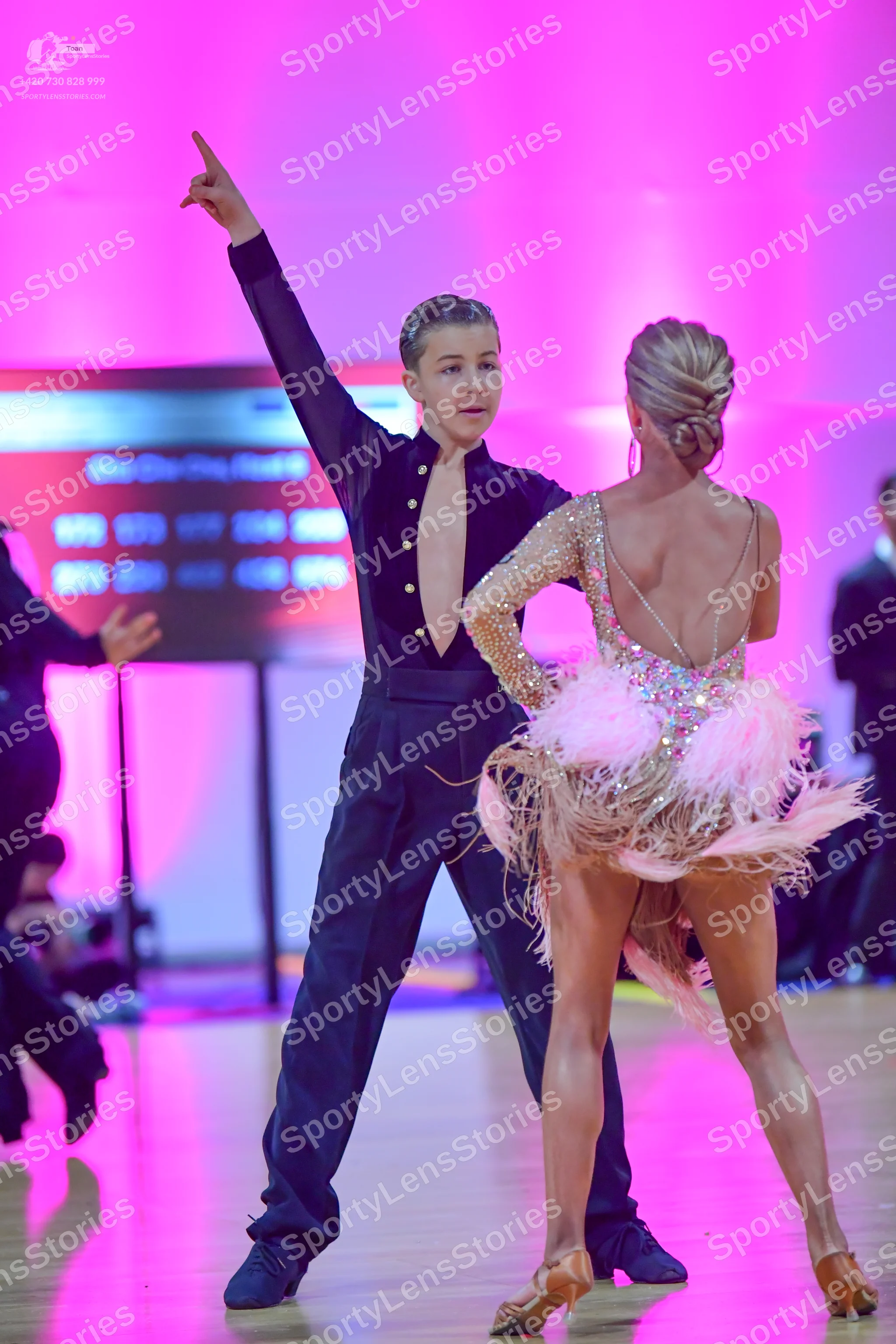 Dancesport competitor: Male dancer: black long-sleeved shirt with a deep V-neckline and buttons, black