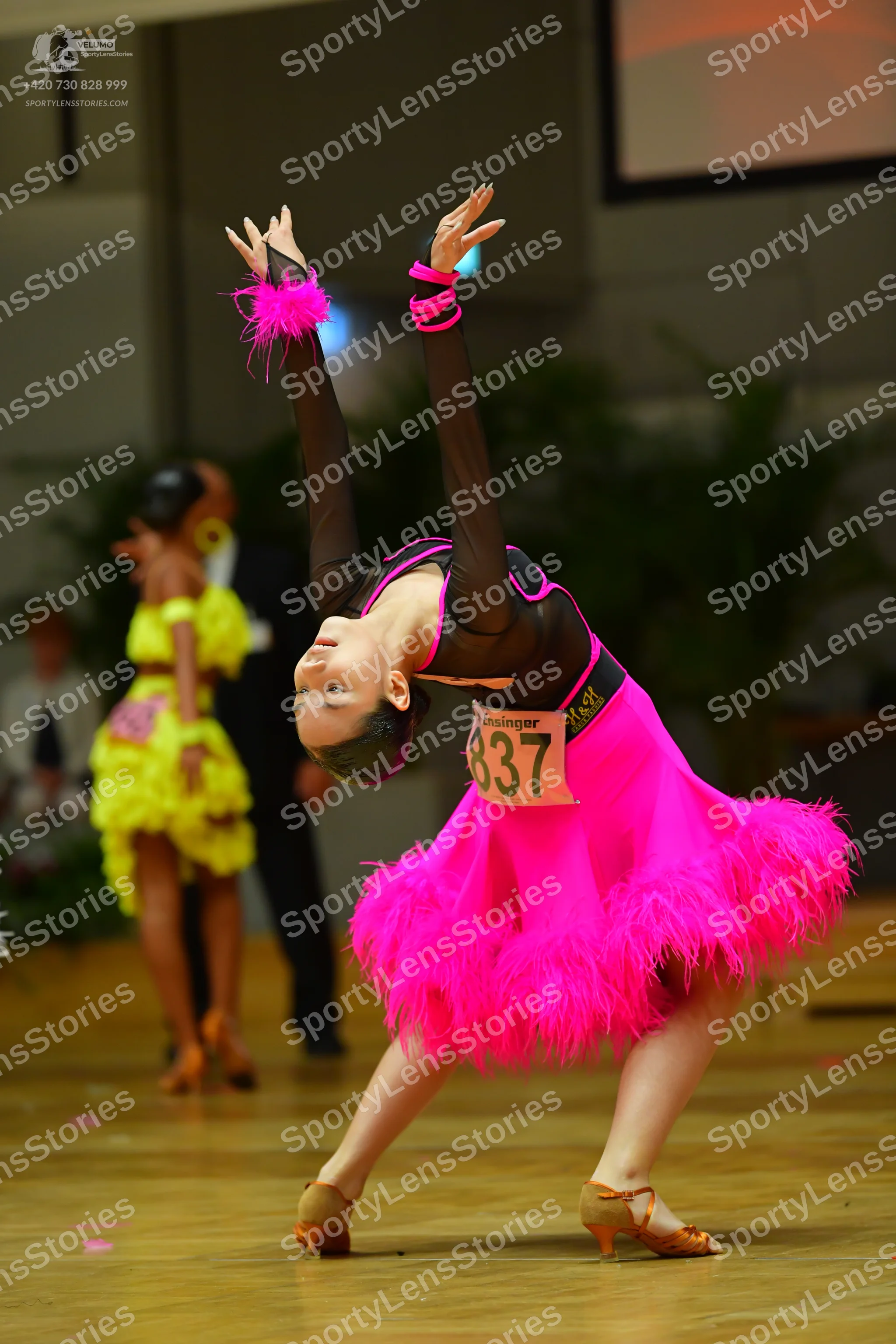 Dancesport competitor #837: Foreground female dancer: bright pink Latin dress with a black bodice and a volu