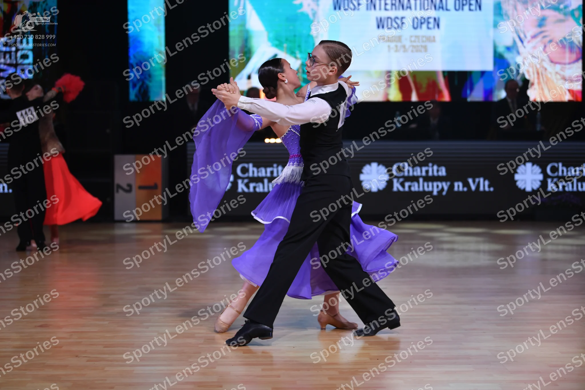 Dancesport competitor: Male dancer: black vest, white long-sleeve shirt, and black trousers