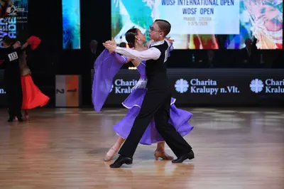 Dancesport competitor: Male dancer: black vest, white long-sleeve shirt, and black trousers
