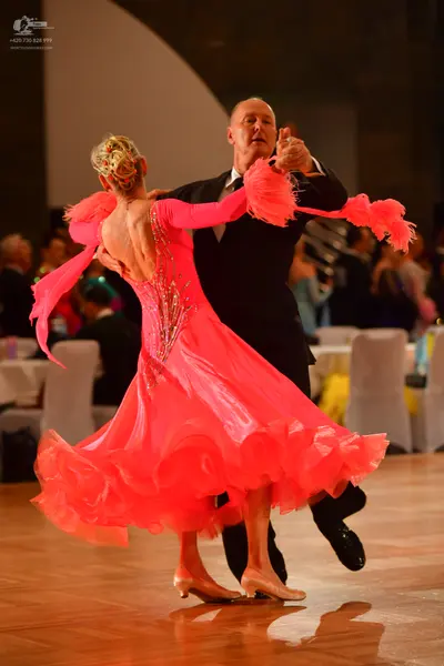 Dancesport competitor: Male dancer: black suit with a white shirt and dark tie