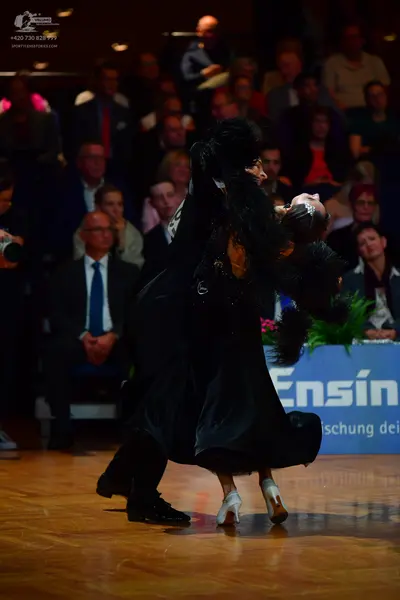 Dancesport competitor: Male dancer: black suit