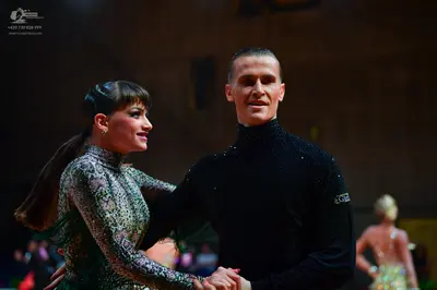 Dancesport competitor: Male dancer: black long-sleeved high-neck top with subtle shimmer