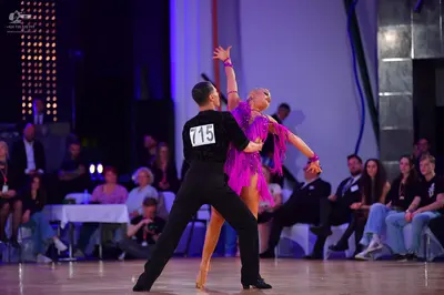 Dancesport competitor #715: Male dancer: black long-sleeved shirt and black trousers