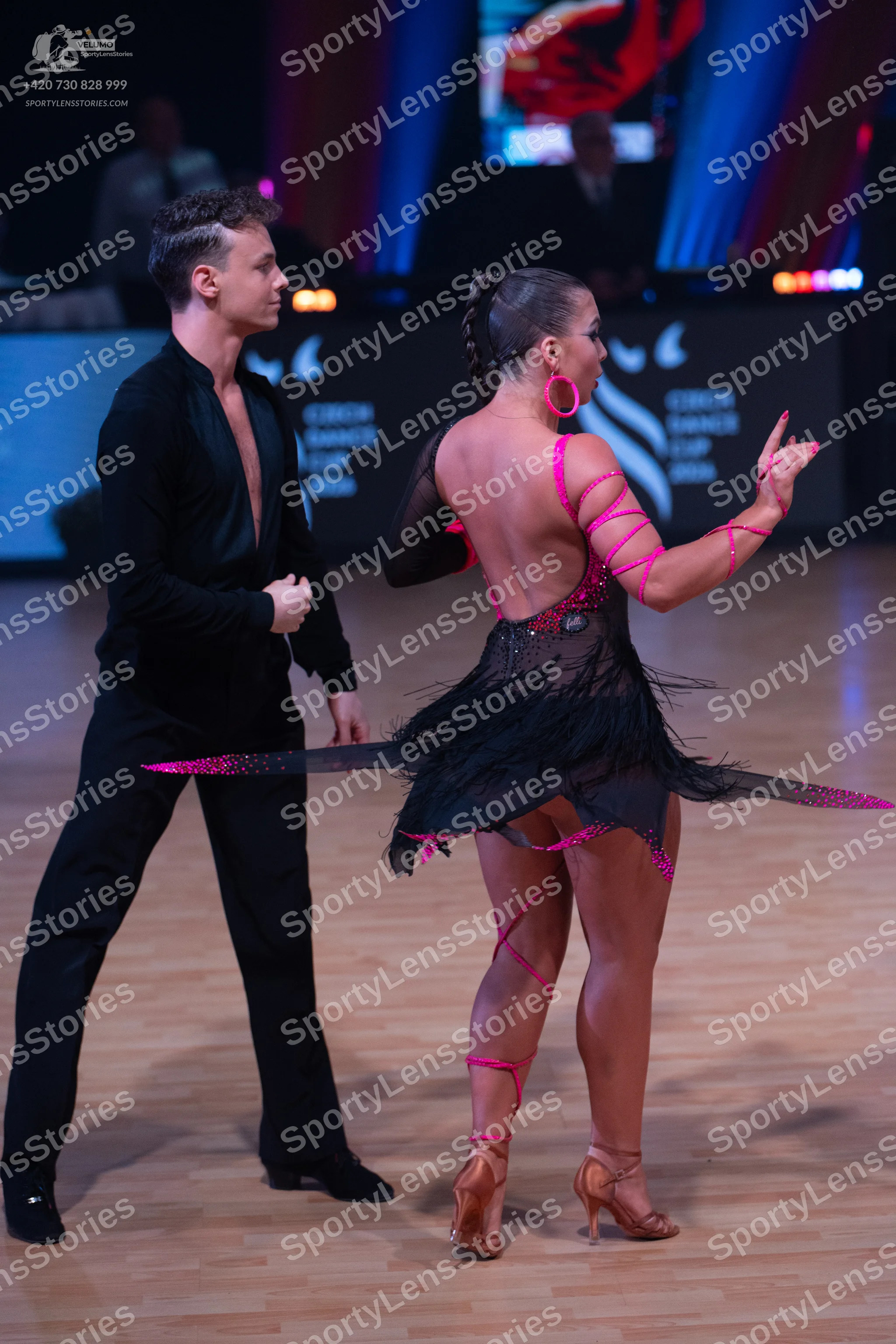 Dancesport competitor: Male dancer: black long-sleeved shirt with a deep V-neck and black trousers