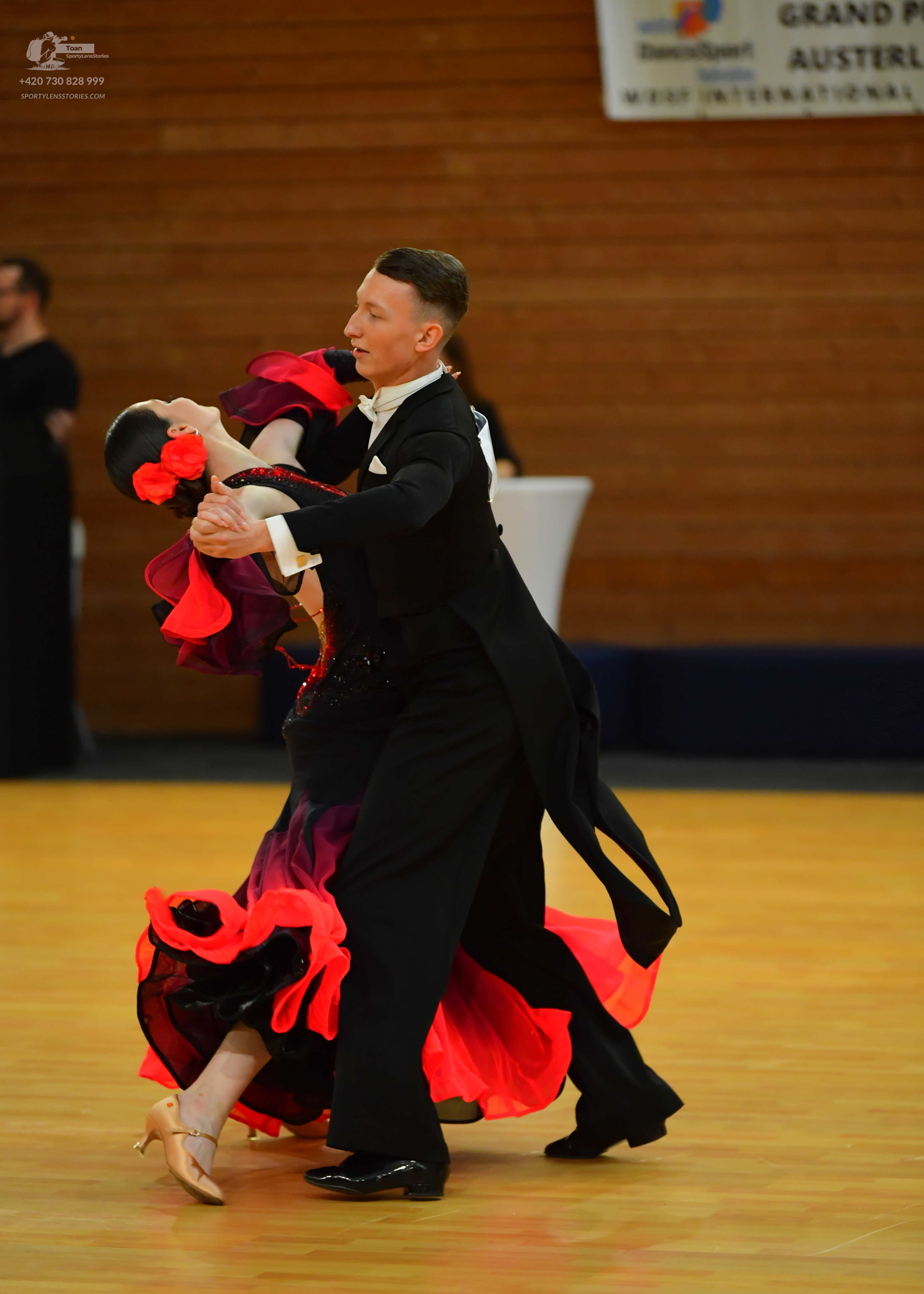 Dancesport competitor: **

*   **Male:** Black tail suit with red sequin detailing on the lapels and al