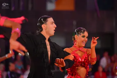 Dancesport competitor: Male dancer: black long-sleeved latin dance shirt with ruffles