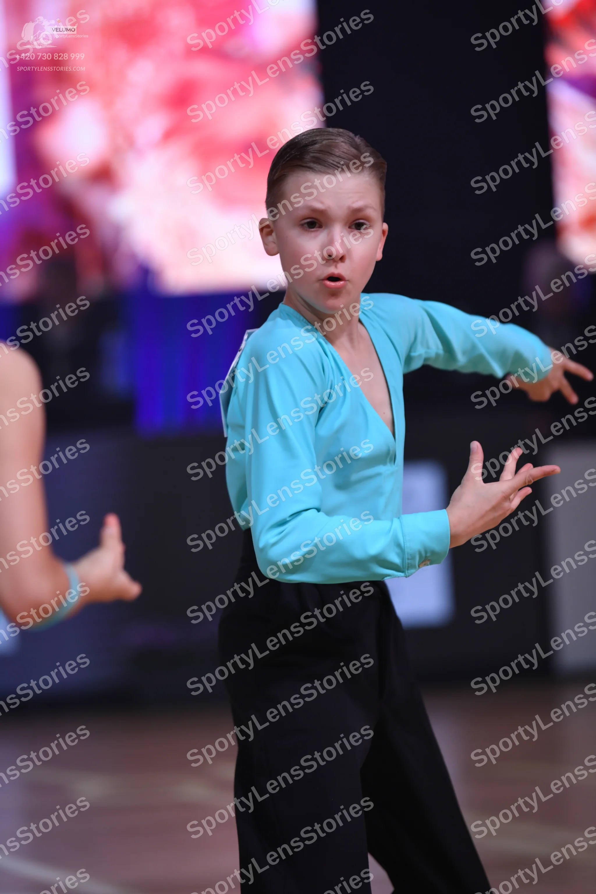 Dancesport competitor: Male dancer: light blue long-sleeved V-neck top and black trousers